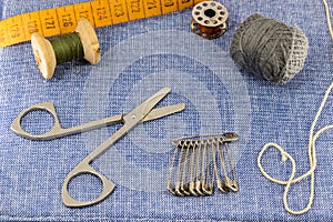 Beautifully laid out accessories for needlework on a jeans background