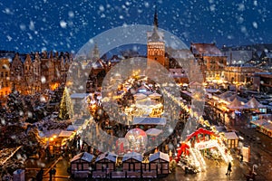 Beautifully lit Christmas market in the Main City of Gdansk during a snowfall. Poland photo