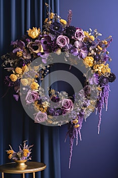 A beautifully natural wreath hang on violet background. Wreath decorate with violet and yellow dried flowers.