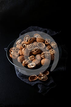 Beautifully presented walnuts on dark slate plate kitchen table