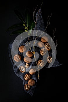 Beautifully presented walnuts on dark slate plate kitchen table