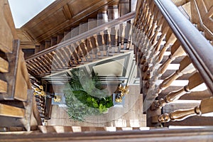 These beautifully restored wooden stairs lead to a planter flanked by golden candlesticks in the Paleis het Loo