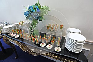 Beautifully served snacks of , cheese and vegetable salad on a wedding cocktail, meeting and press conference side table