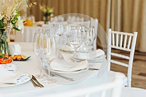 Beautifully set tables with glasses and appliances