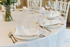 Beautifully set tables with glasses and appliances