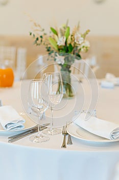 Beautifully set tables with glasses and appliances