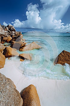 Beautifully shaped granite boulders and blue lagoon at Grand Anse beach, La Digue island, Seychelles