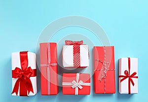 Beautifully wrapped gift boxes on color background