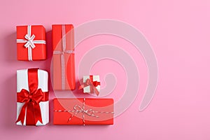 Beautifully wrapped gift boxes on color background