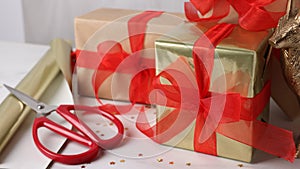 Beautifully wrapped gift boxes on white table, closeup