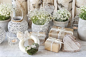 Beautifully wrapped gifts and floral decoration in the background