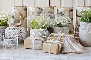 Beautifully wrapped gifts and floral decoration in the background