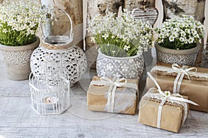 Beautifully wrapped gifts and floral decoration in the background