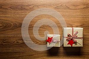 Beautifully wrapped vintage christmas presents on wooden background, view from above photo