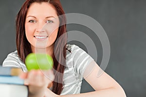 Beautilful young woman showing an apple