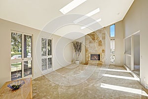 Beautitful living room with vaulted ceiling and skylights. Empty