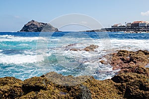 Beautiul seascape on Tenerife island. Rocks with algae, clear blue water and waves of Atlantic ocean. Tenerife, Canary island,