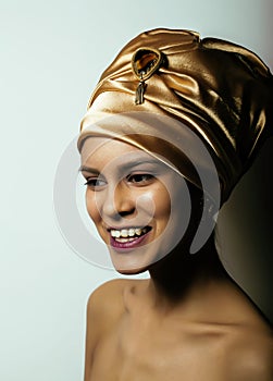 beauty african woman in shawl on head, very elegant look with gold jewelry close up mulatto makeup
