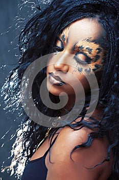 Beauty afro girl with cat make up, creative leopard print closeup, fashion style halloween look