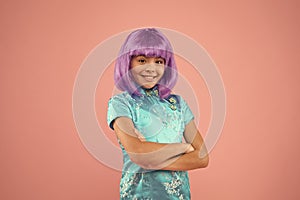 Beauty is all about her. Happy child wear violet hair wig pink background. Beauty look of small fashion model. Beauty