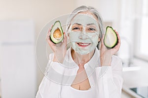 Beauty, antiwrinkle and skincare concept. Close-up of happy good-looking senior grai haired woman in white shirt, with