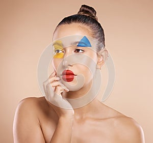 Beauty, art and portrait of woman paint on face, creative makeup and serious self expression. Skincare, creativity and