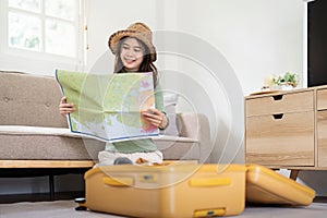 Beauty asian traveler woman packing prepare stuff and outfit clothes in suitcase travel bag luggage for holidays at home