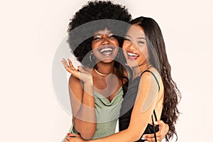Beauty asian woman posing with her friend with afro hairstyle. Cheerful, elegant girls standing together, looking at the camera