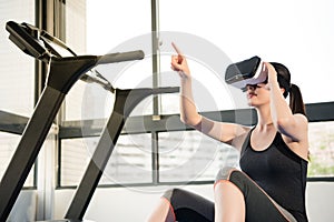 Beauty asian woman rest on treadmill with VR headset