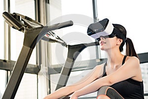 Beauty asian woman rest on treadmill with VR headset