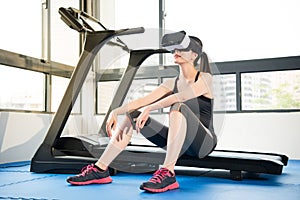 Beauty asian woman rest on treadmill with VR headset