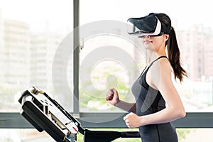 Beauty asian woman running treadmill by VR headset glasses