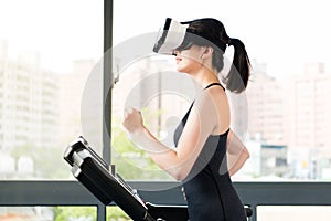 Beauty asian woman running treadmill by VR headset glasses