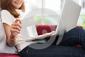 Beauty Asian woman using tablet and showing blank mock up credit card for online shopping payment with high speed internet.