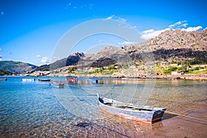 Beauty Atlantic coast with fishing boats, beach, ocean, village, mountains and sky with clouds. Galicia, Spain