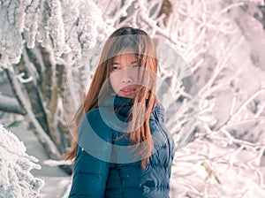 Beauty woman with winter fashion clothing with beautiful skin face in snow skii resort, closed up portrait photo