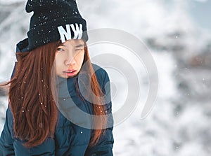 Beauty woman with winter fashion clothing with beautiful skin face in snow skii resort, closed up portrait photo