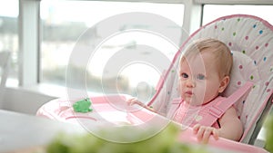 Beauty baby girl eating apple. Toddler missed food from hand. Baby fruit eating