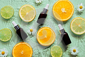 Beauty background with organic cosmetics products bottles, citrus fruits, concentric circles and ripples