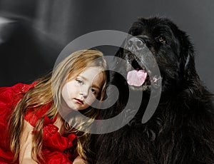 Beauty and the Beast. Girl with big black water-dog.