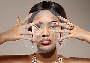 Beauty black skin woman African Ethnic female face. Luxury Young african american model with jewelry, earrings and ring photo