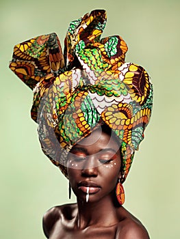 Beauty, black woman and queen makeup with African head wrap and pride with fashion. Isolated, green background and young