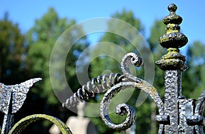 The beauty of blacksmithing in old rural cemeteries metal, brass and copper poppy flowers, balls, walled lattice lamps and inscrip