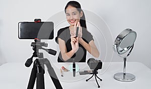 Beauty Blogger. Asian teen woman sit in front of camera and live broadcasting