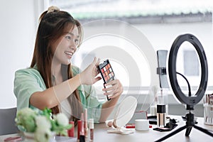 Beauty blogger concept, Young woman show eyeshadow to presenting product and record video for Vlog