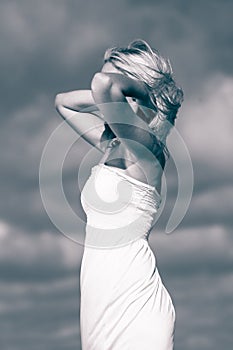 Beauty blonde woman portrait on sky background