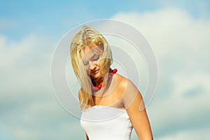 Beauty blonde woman portrait on sky background.