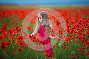 Beauty blue eyes teen enjoy summer days .Cute fancy dressed girl in poppy field. Field of blooming poppies