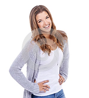 Beauty in blue jeans. A young woman in casual wear standing against a white background and smiling at the camera.