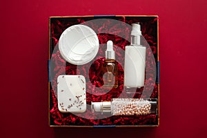 Beauty box subscription package and luxury skincare products, spa and cosmetic body care product flat lay on red